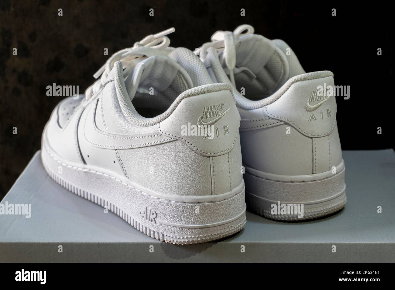 Nike Air Force 1 white sneakers isolated on dark background. Illustrative editorial photo. Stock Photo