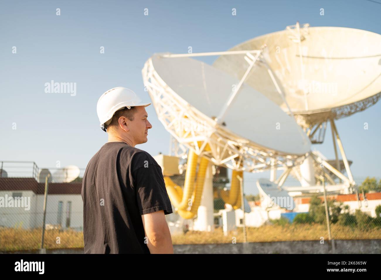 Engineer looking earth based astronomical radio telescope. Radio telescopes used in science for