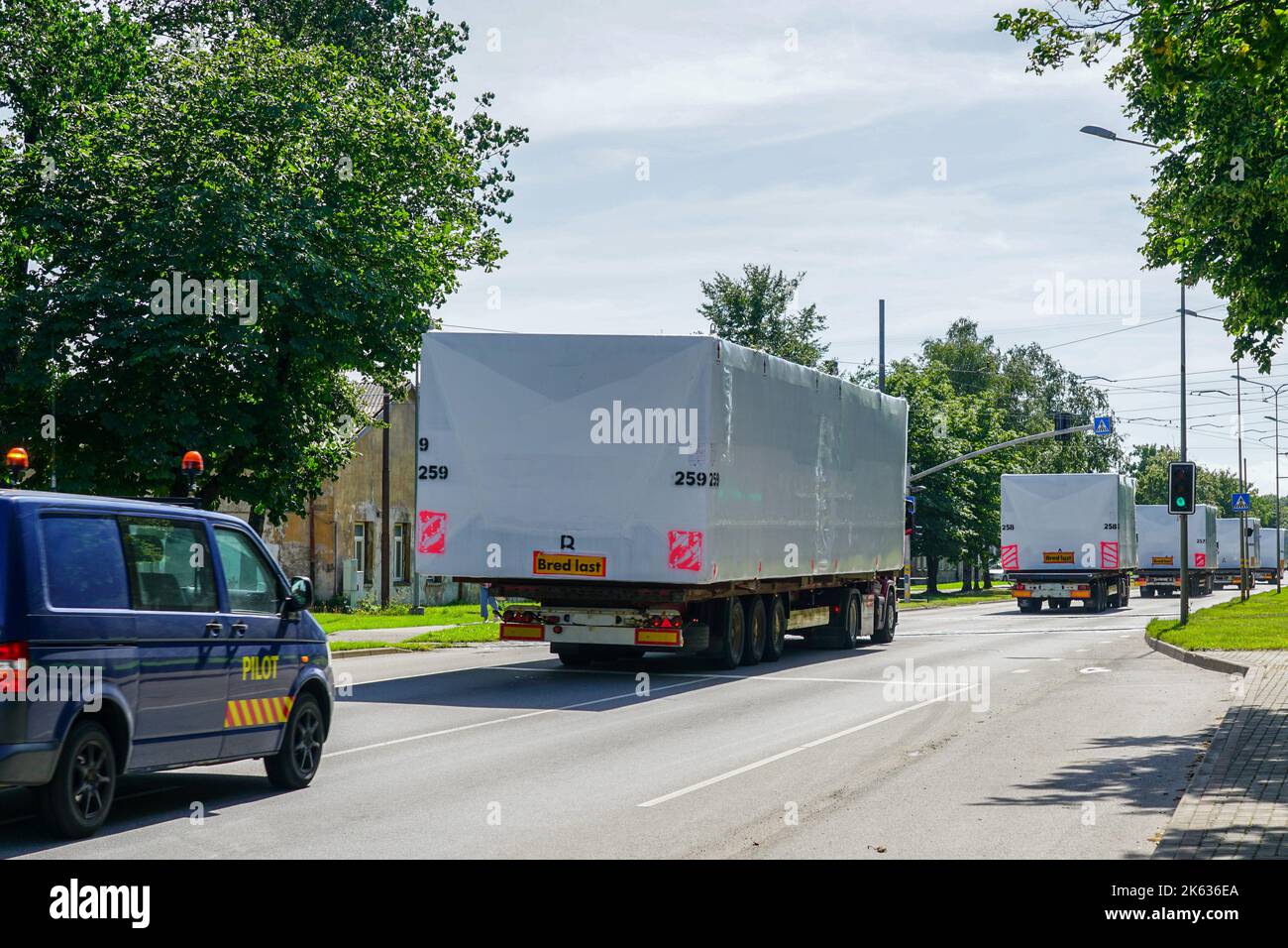 Transportation of oversized cargo on public roads with an accompanying escort car Stock Photo