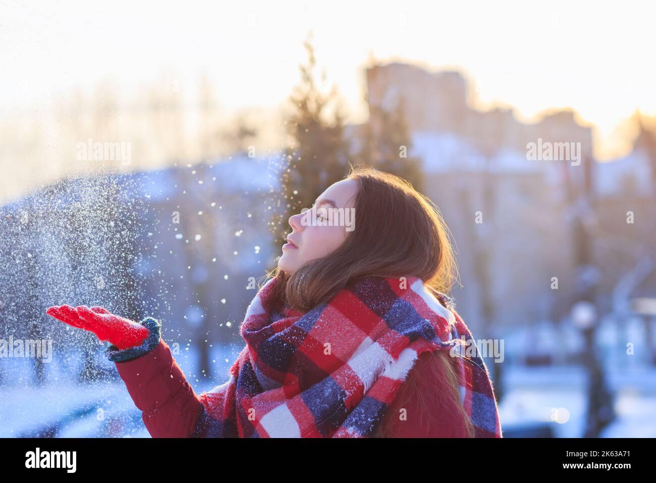Winter teenager girl portrait. Beauty Joyful Model Girl having fun in winter park. Enjoying nature, wintertime. Stock Photo