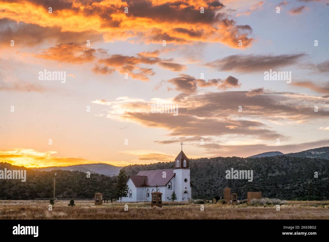 La Garita, Colorado, USA;  Iglesia de San Juan at sunset, mountains by Penitente Canyon Stock Photo