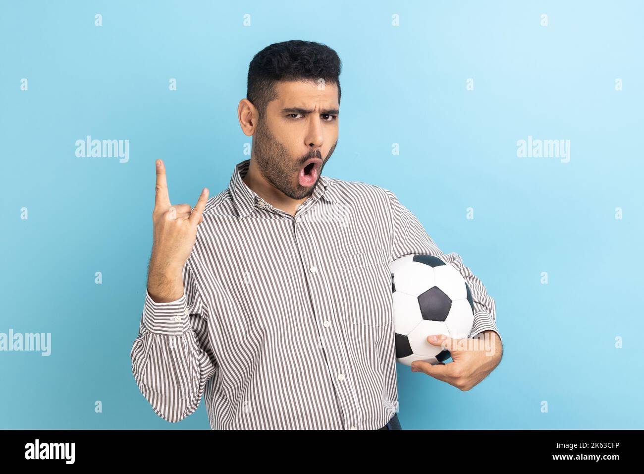 Excited businessman celebrating victory of favourite football team