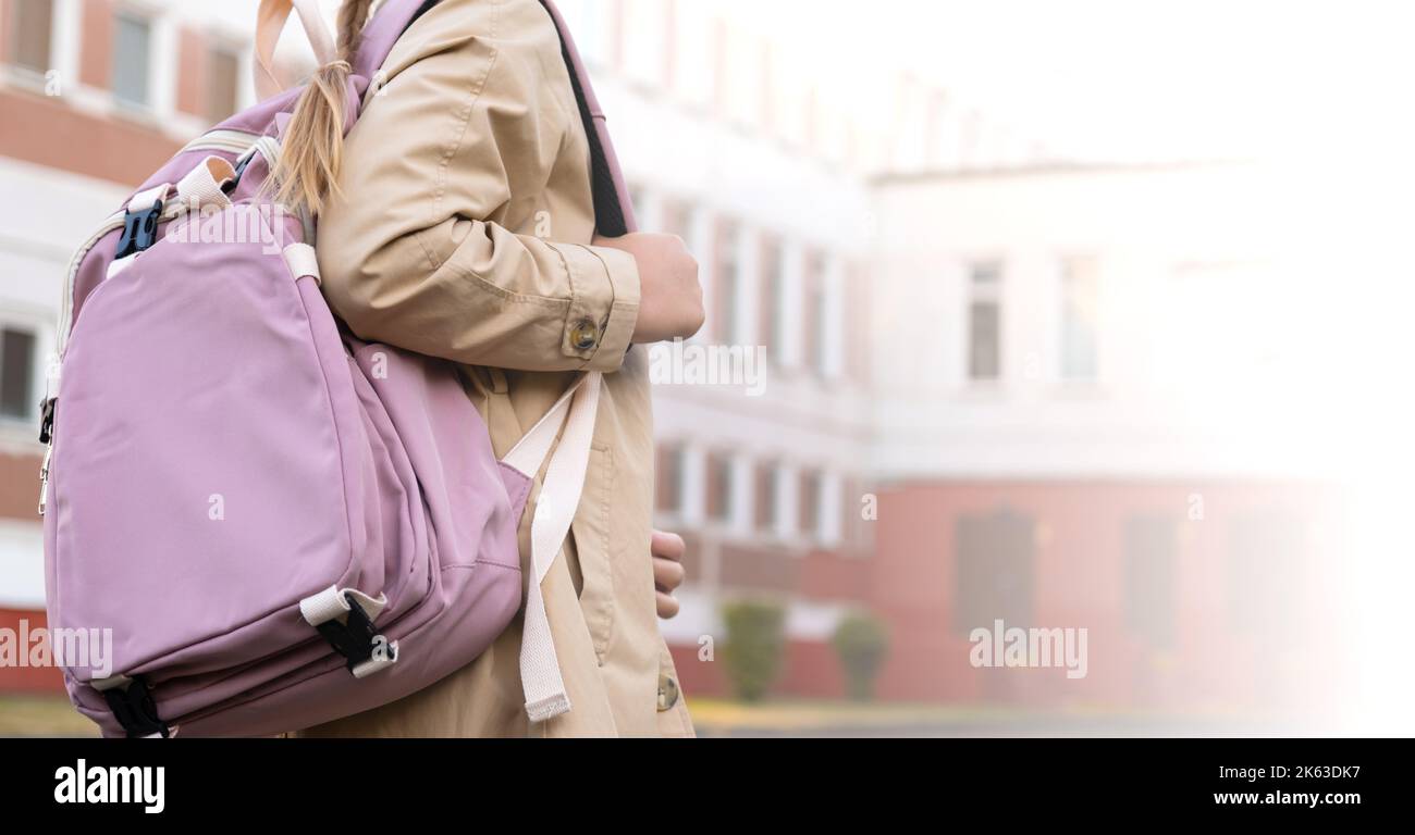 Back of school backpack, schoolgirl going to school with backpack, university back, teenage college student walking on campus background, education Stock Photo