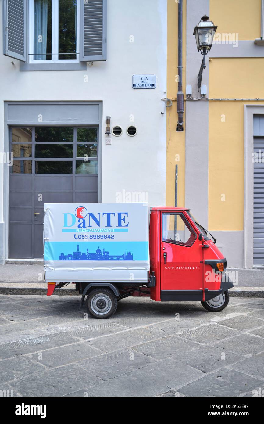 Typical Three Wheeled Vehicle Piaggio Ape Van for an Apartment Cleaning Service in Florence Italy Stock Photo