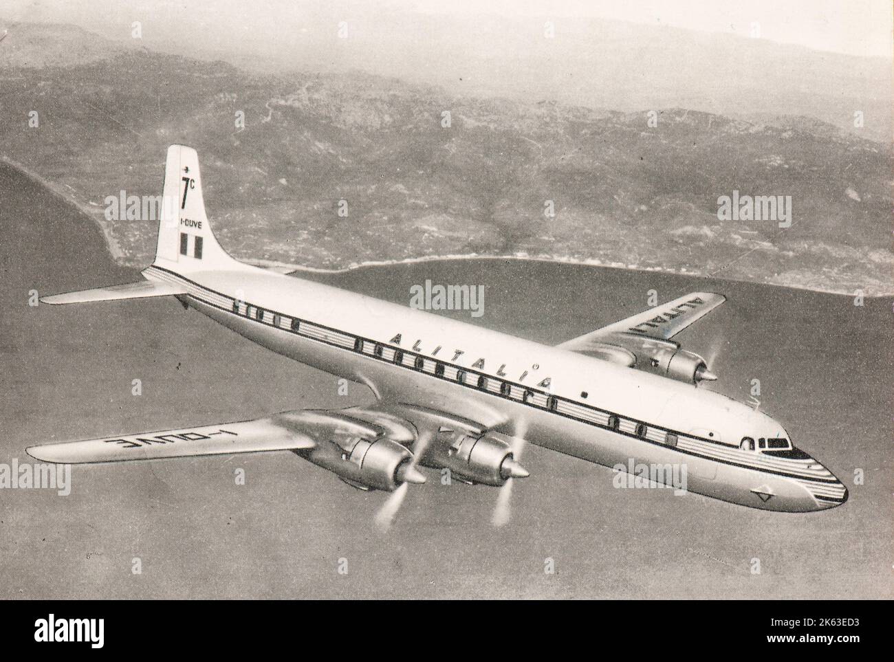 Former Alitalia airline DC7 aircraft flying over Italy coast in late fifties Stock Photo