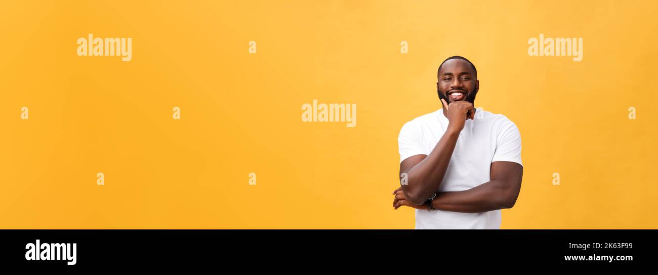 Portrait of a modern young black man smiling with arms crossed on ...