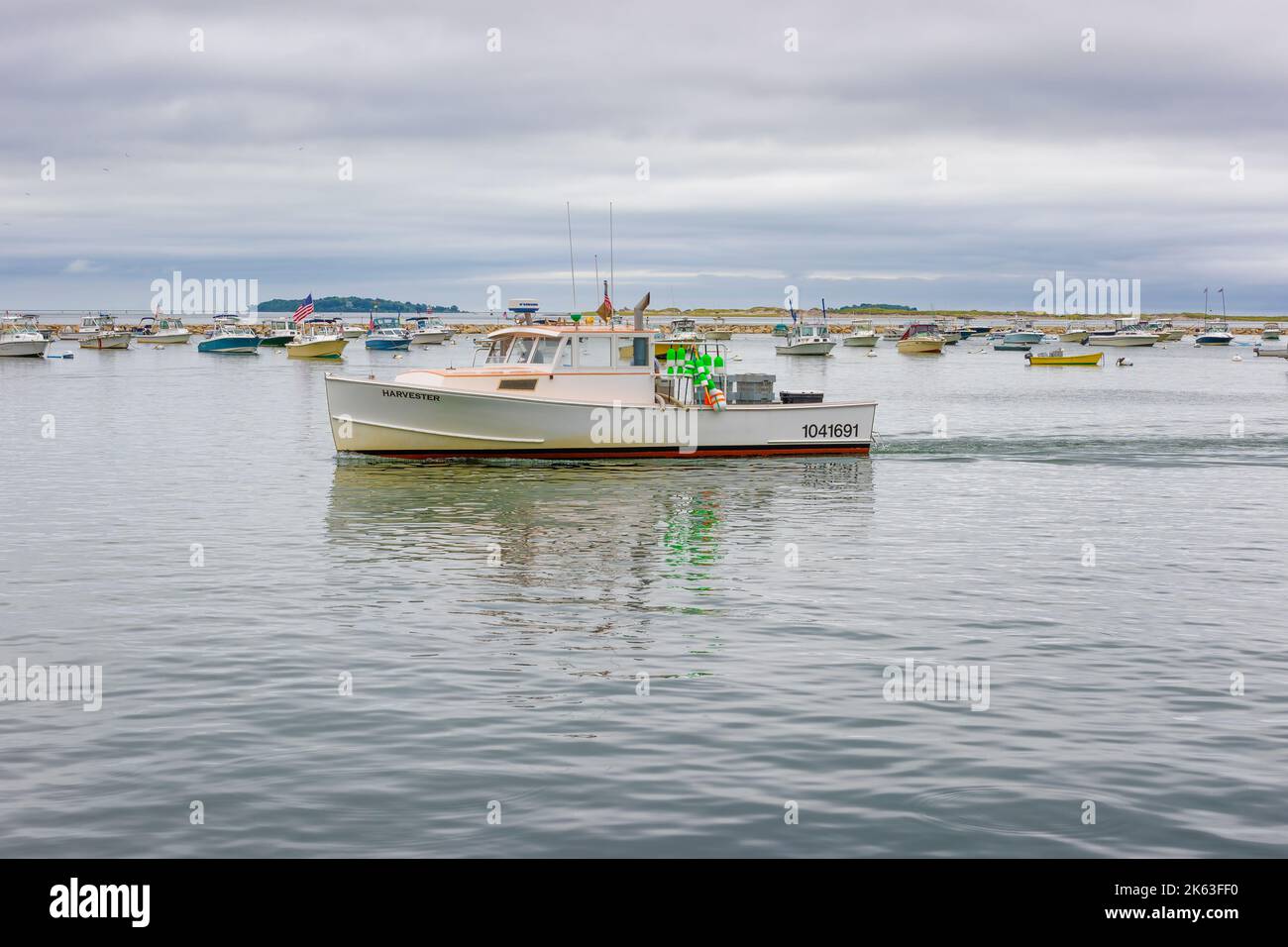 Plymouth, Massachusetts, USA - September 12, 2022:Fishing boat makes it way to pier to unload it's catch on Cape Bay at Plymouth Harbor. Stock Photo