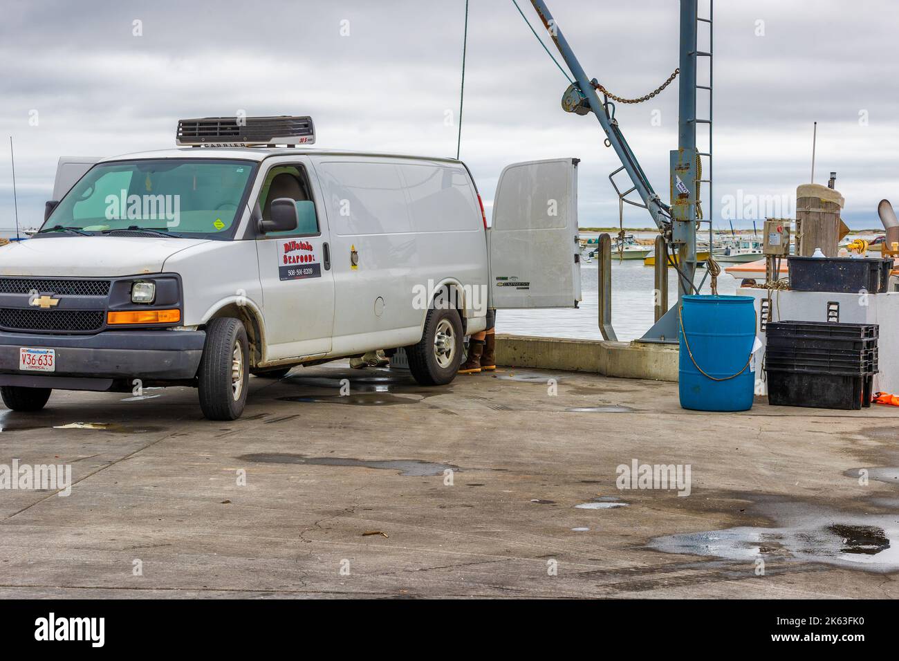 Plymouth, Massachusetts, USA - September 12, 2022:loading a van with fresh caught seafood from a boat at Plymouth harbor Stock Photo