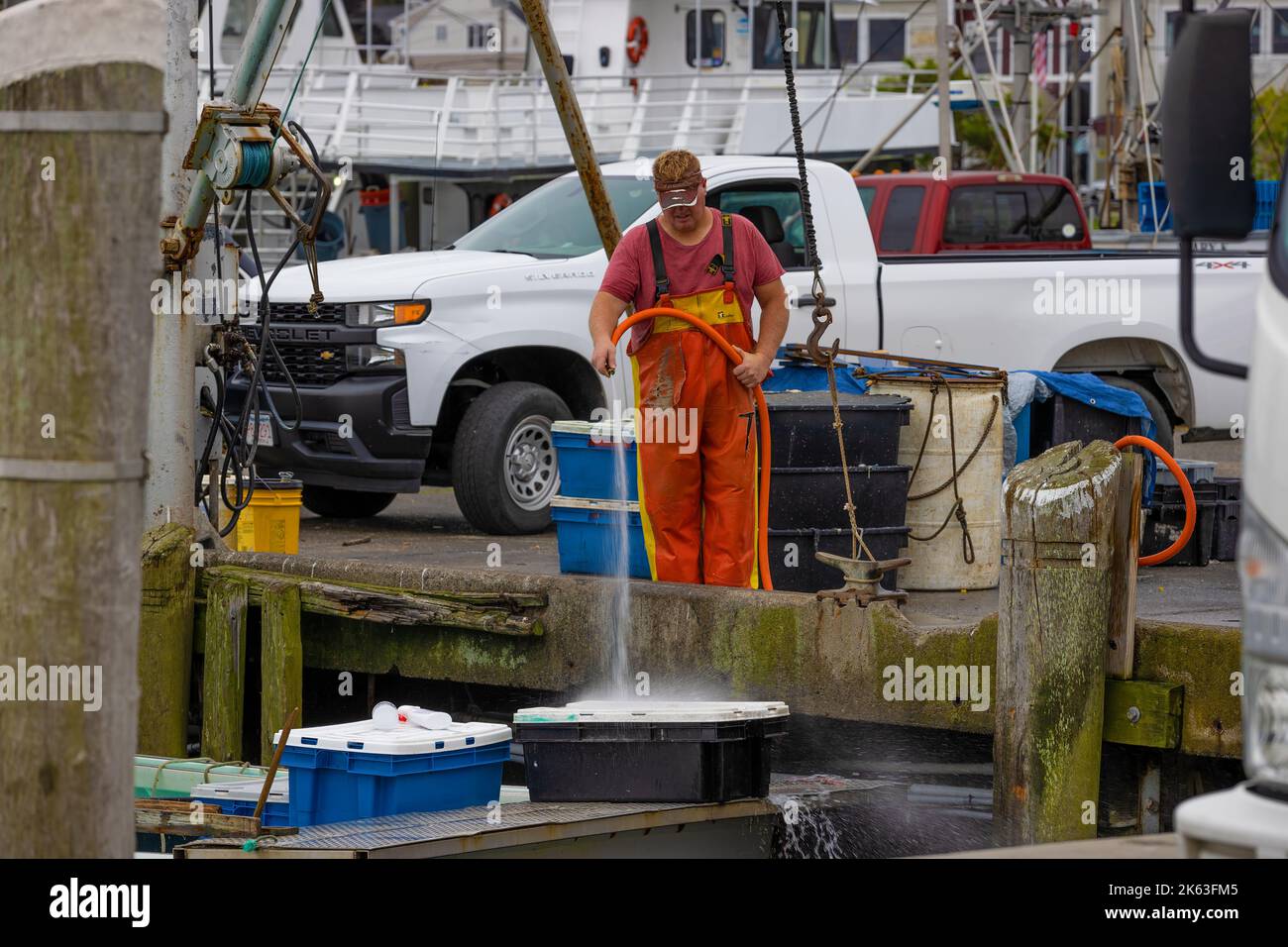 Plymouth, Massachusetts, USA - September 12, 2022: A fisherman rises off containers on his boat from the dock. Stock Photo