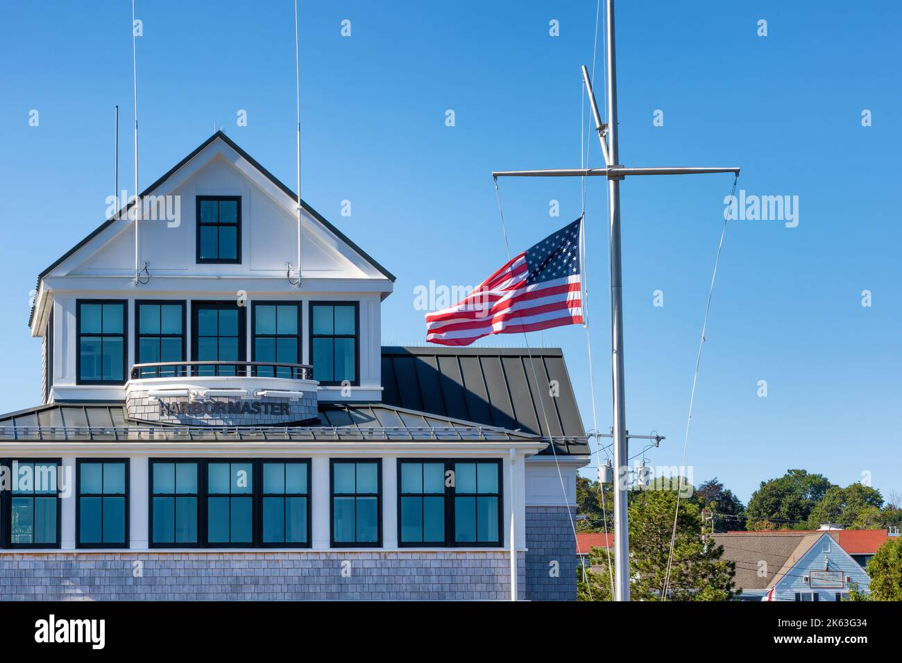 Plymouth, Massachusetts, USA - September 15, 2022: Harbor Master head quarters with the American Flag flyin in the breeze at Plymoth Harbor. Stock Photo
