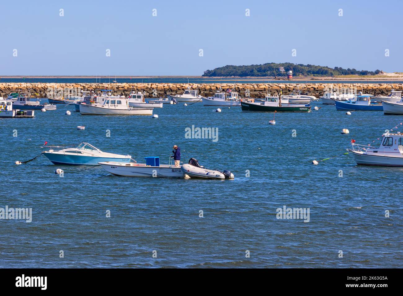 Plymouth, Massachusetts, USA - September 15, 2022:Boats anchored in the harbor with the dike in the background. Stock Photo