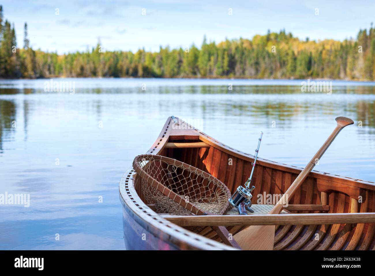Selective focus view of wooden canoe with vintage fishing rod and net on a Boundary Waters lake Stock Photo