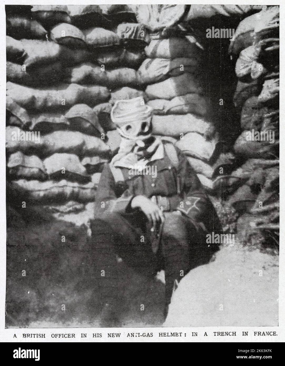 British Officer in 'anti-gas helmet' (gas mask) in trench on Western Front.       Date: 1915 Stock Photo