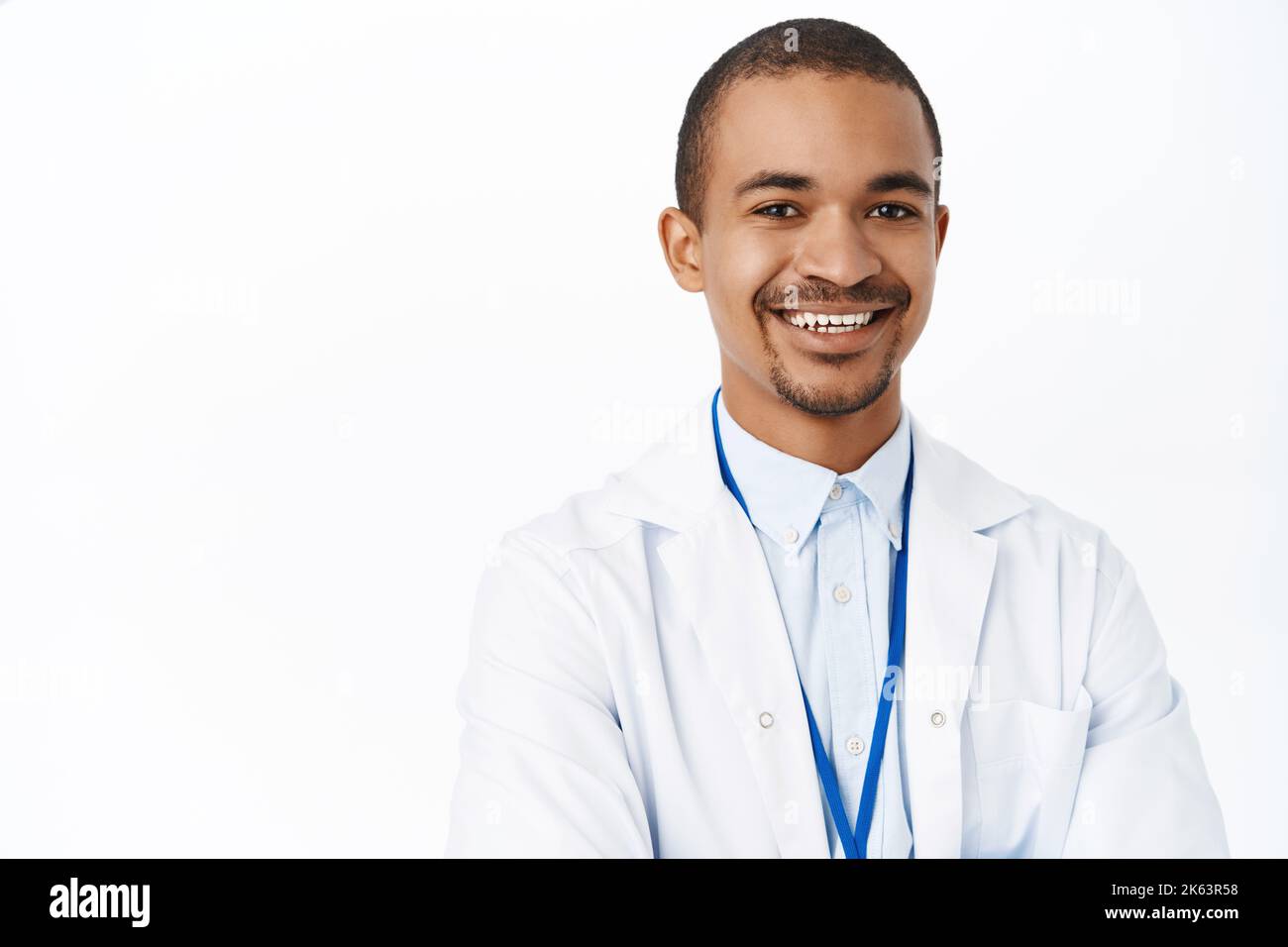 Portrait of smiling Arab doctor in medical uniform, looking