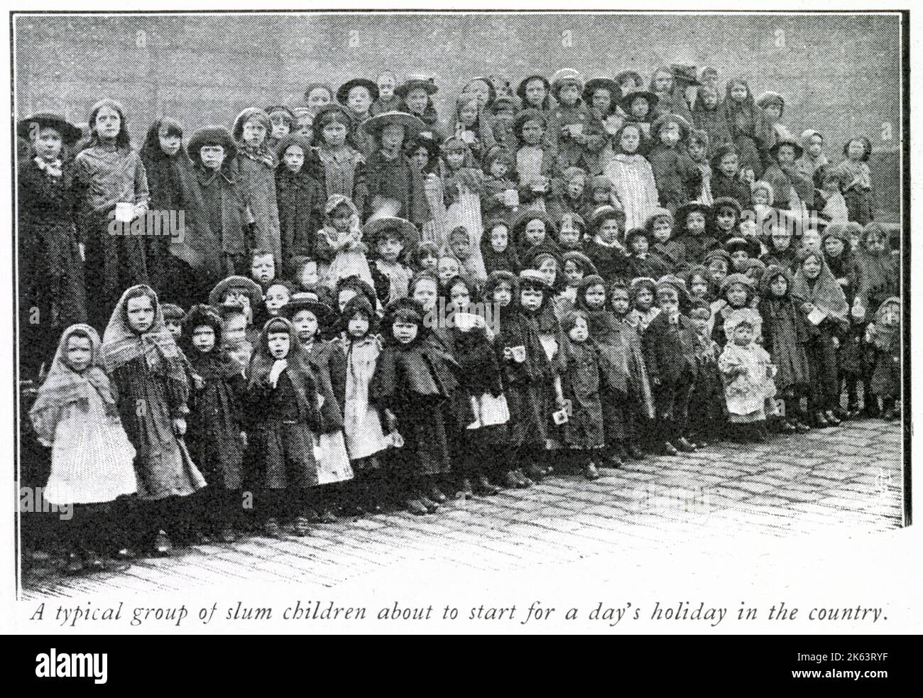 A large group of slum children from London about to go on a day trip to the countryside thank to the christian charity, Salvation Army.     Date: 1904 Stock Photo