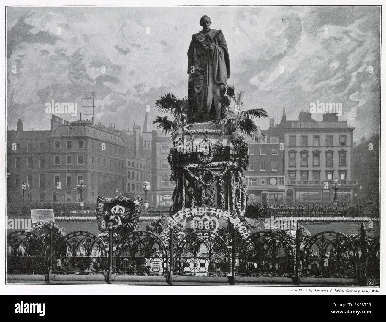 Lord Beaconsfield's bronze statue, facing St. Margaret's Church,  in Parliament Square, London on Primrose Day. On the anniversary of the death of British statesman and prime minister Benjamin Disraeli, 1st Earl of Beaconsfield, on 19 April 1881. The primrose was his favourite flower and Queen Victoria would often send him bunches of them from Windsor and Osborne House. Stock Photo