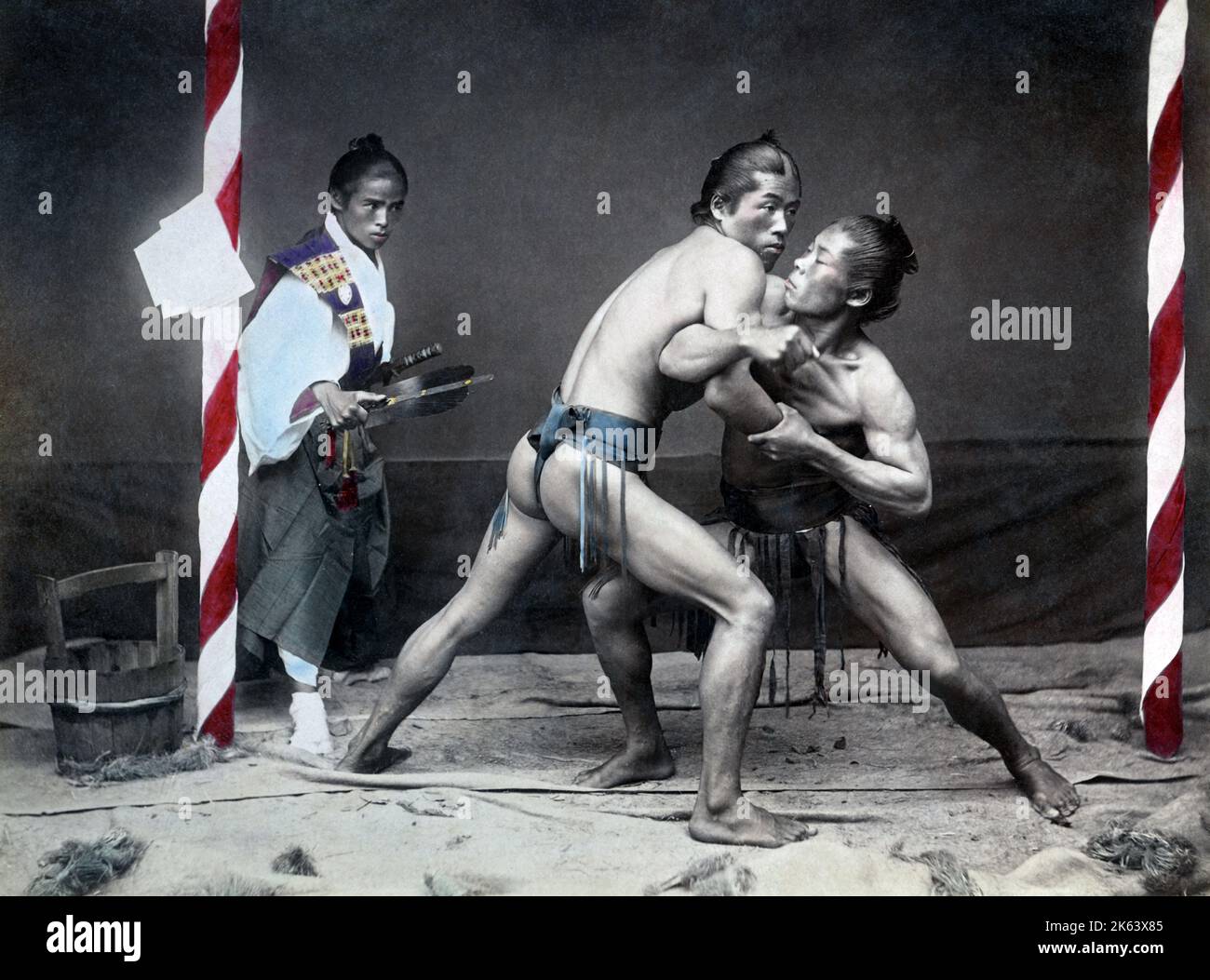Sumo wrestlers and referee, Japan, circa 1890. Stock Photo