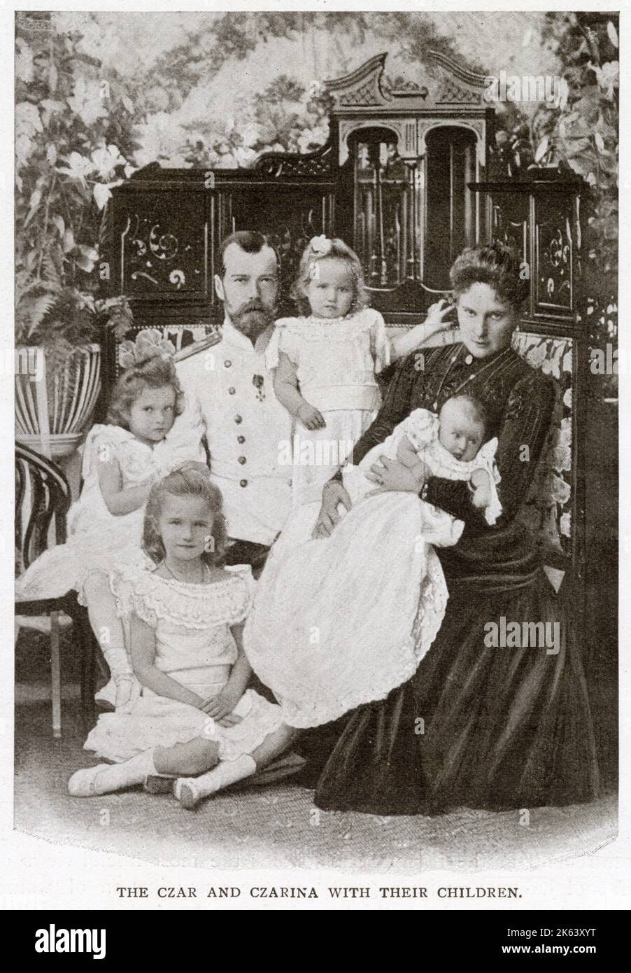 Nicholas II of Russia (1868 - 1918), the last Emperor of Russia, ruling from 1 November 1894 until his forced abdication on 15 March 1917 with his wife Alexandra Feodorovna and their four children: The Grand Duchess Olga (sitting on floor), the Grand Duchess Tatiana (left), the Grand Duchess Marie (middle) and four month old baby Grand Duchess Anastasia.      Date: 1901 Stock Photo