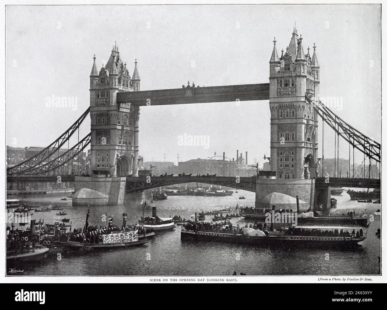 Tower Bridge was designed by Sir Horace Jones and Mr. Wolfe Barry, comprises a permanent footway 142ft above high-water level and a drawbridge for passing ships. Photograph showing the day of opening with crowds of people watching from boats on the River Thames. Stock Photo