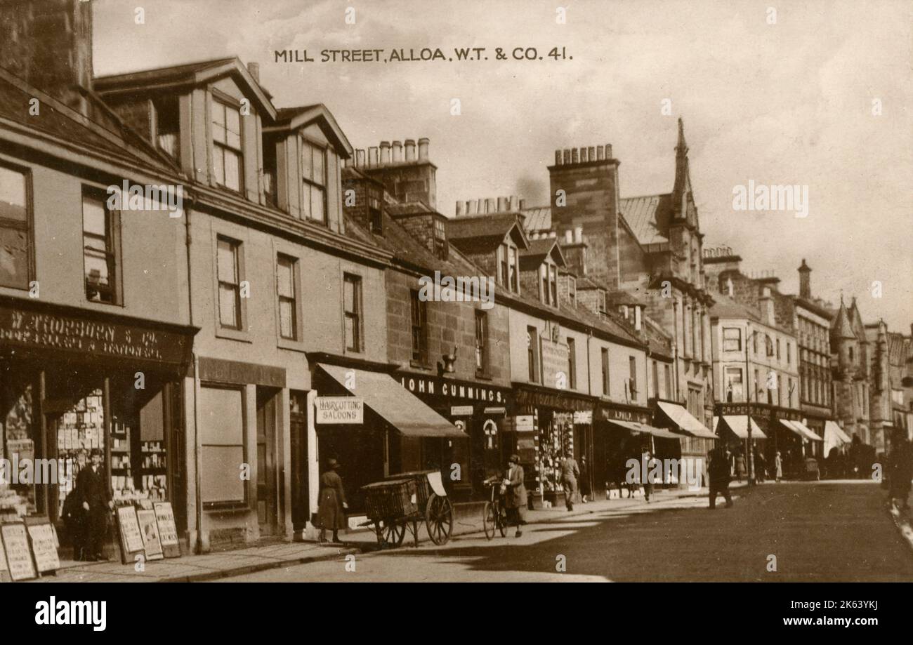 The shops on Mill Street, Alloa, Scotland. The Book Seller and Stationers shop of this postcard's publisher (Walter Thorburn &amp; Co.) can be seen on the left. circa 1910s Stock Photo
