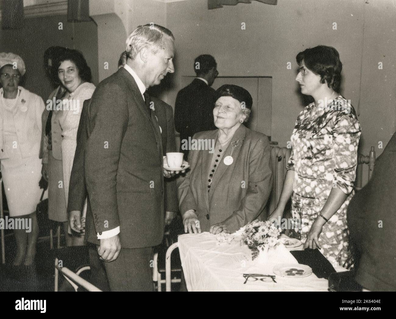 Sir Edward Richard George 'Ted' Heath (1916-2005) - British politician who served as Prime Minister of the United Kingdom from 1970 to 1974 and Leader of the Conservative Party from 1965 to 1975. Pictured here chatting to some ladies at a Conservative Party event. Stock Photo