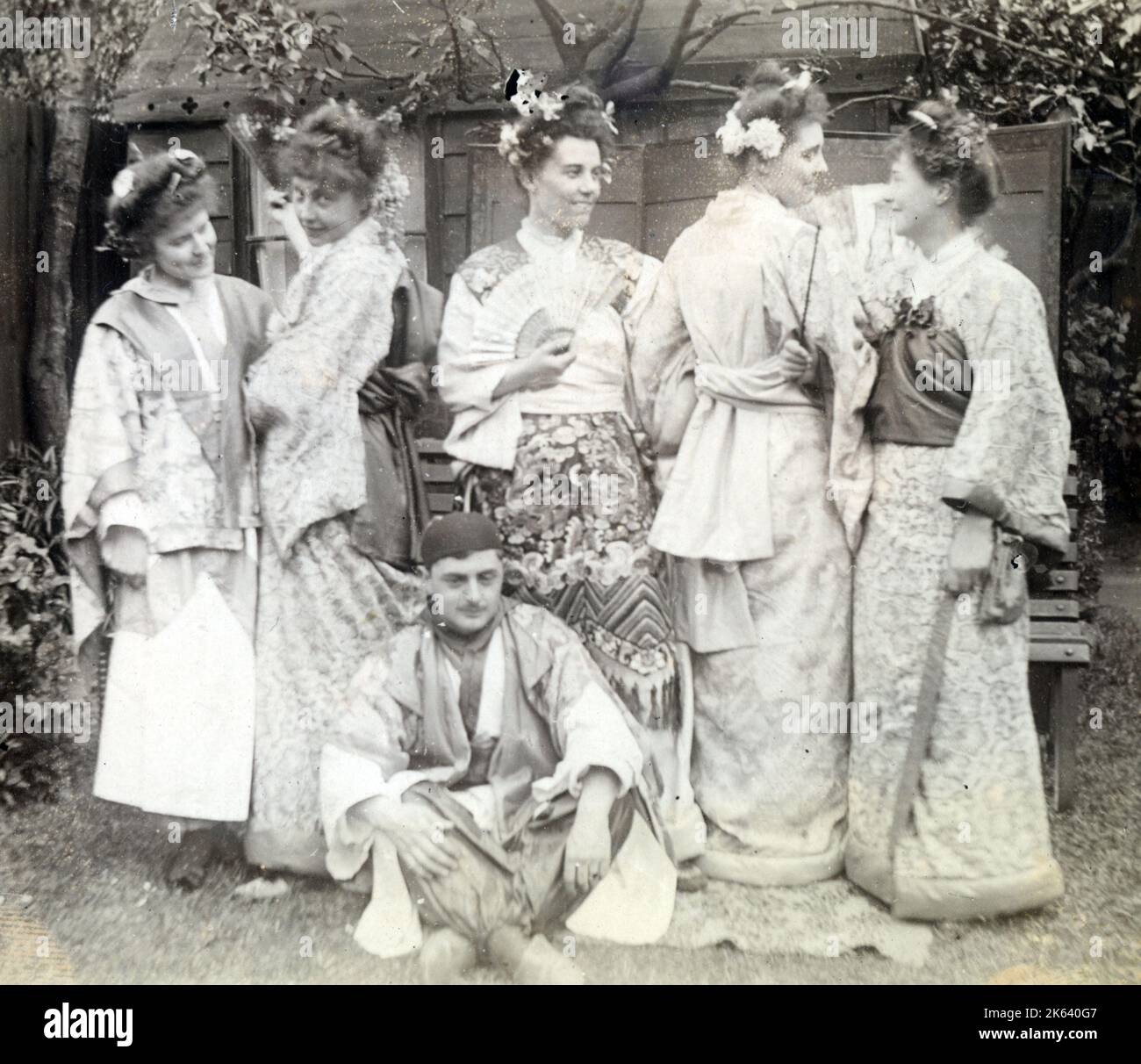 A group of 1920s men and women in fancy dress - all wearing pseudio-Japanese attire. Stock Photo