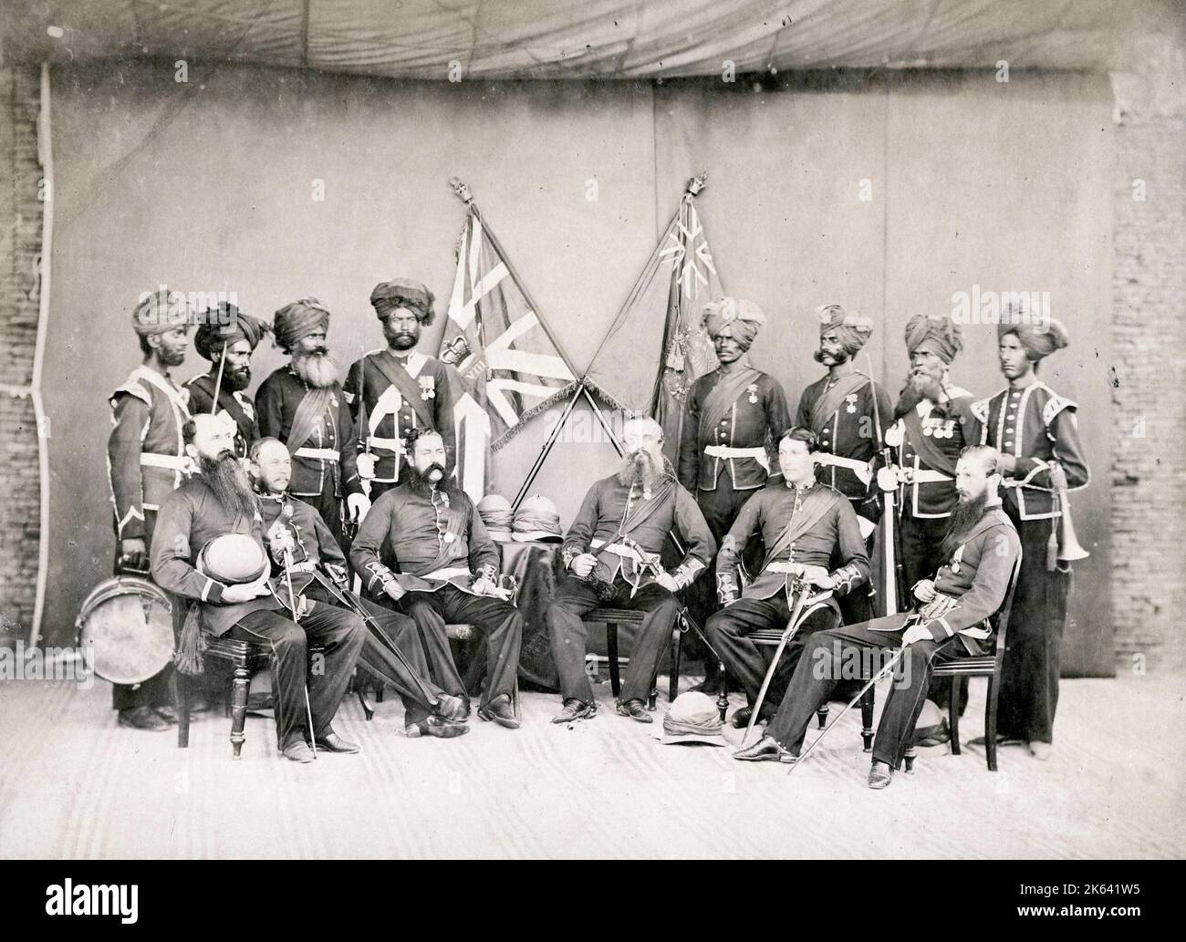 Officers in a British army regiment, India, 19th century probably 8th (The King's) Regiment of Foot, with banners Stock Photo