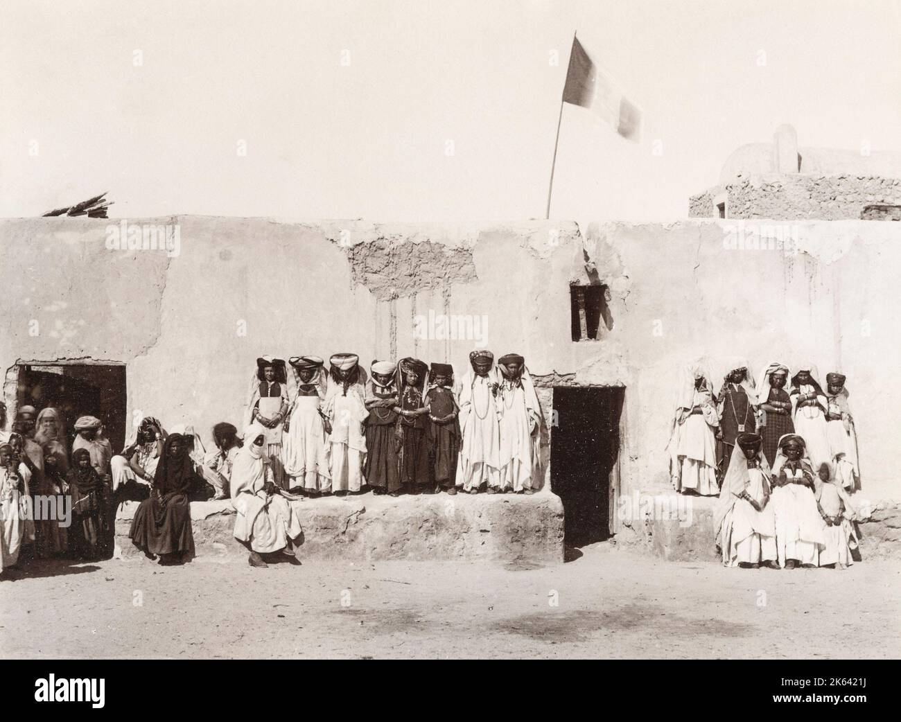 Group of women, Ouled Nail, Algeria, with French flag flying. Vintage 19th century photograph Stock Photo