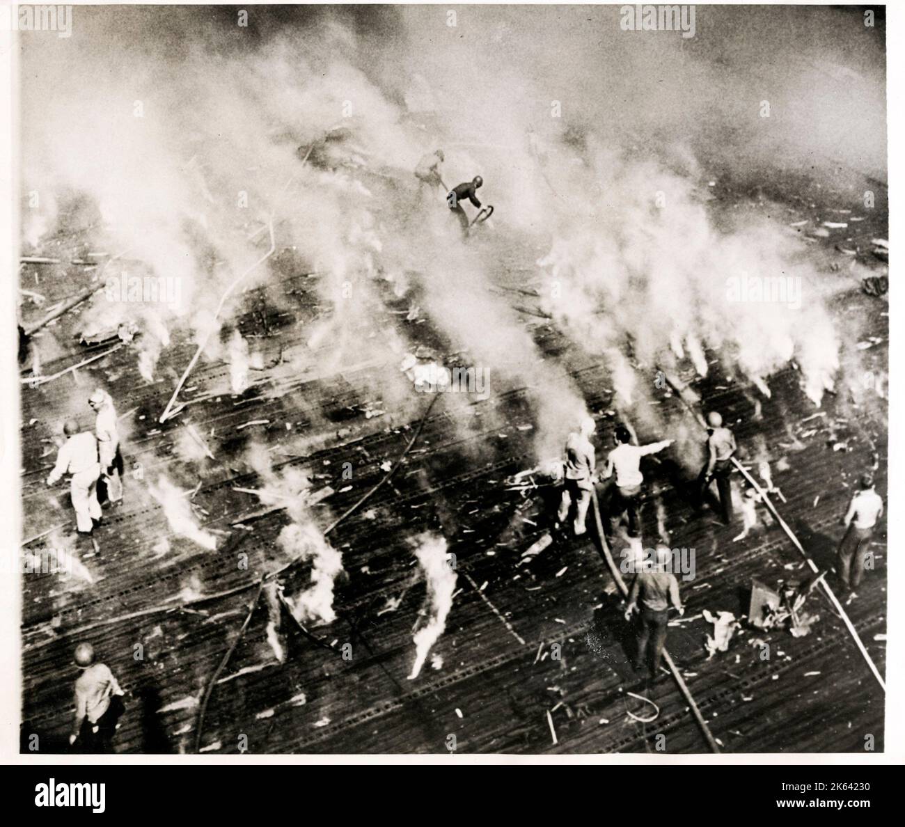 World War II -  crew of USS Intrepid aircraft carrier work out put out fires caused by Jaapanese incendiaries. Stock Photo