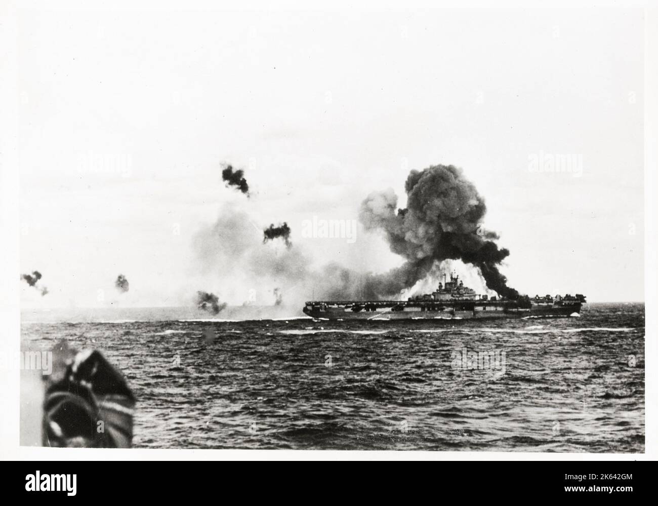 World War II vintage photograph - fire on USS Intrepid aircraft caarrier after near miss from Japanese aircraft suicide attack Stock Photo