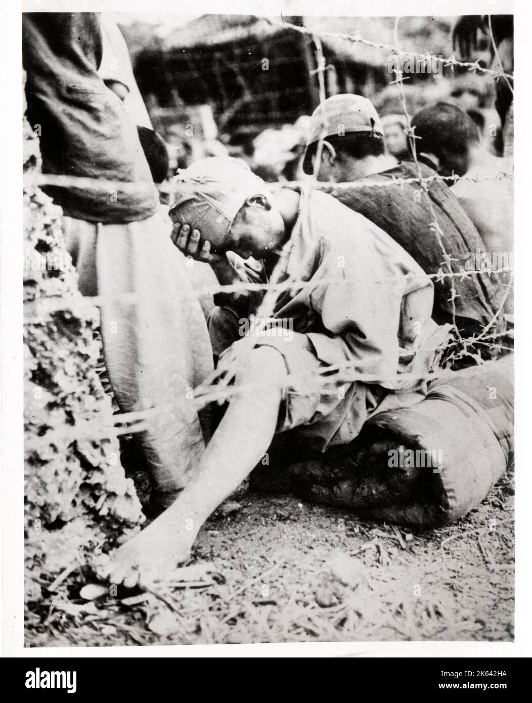 World War II vintage photograph - Japanese soldier held prisoner in a stockade on Okinawa Stock Photo