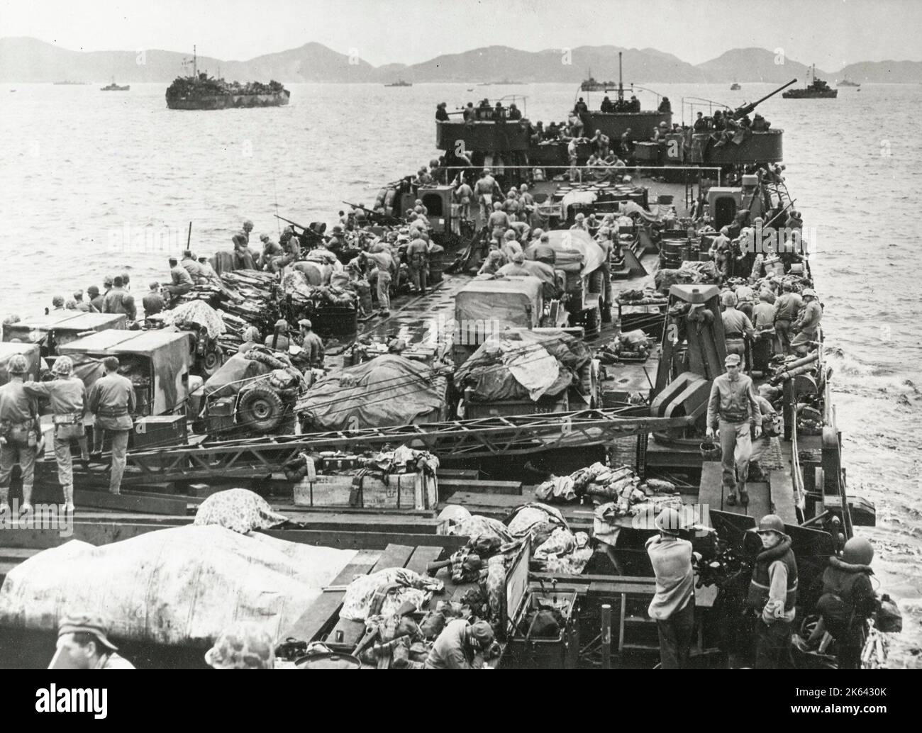 Vintage World War II photograph - US landing craft approaches Iheya Island in the Pacific Stock Photo