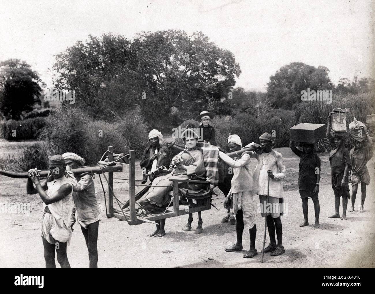 19th century vintage photograph: Woman in a carrying chair, sedan, litter, with porters, India Stock Photo