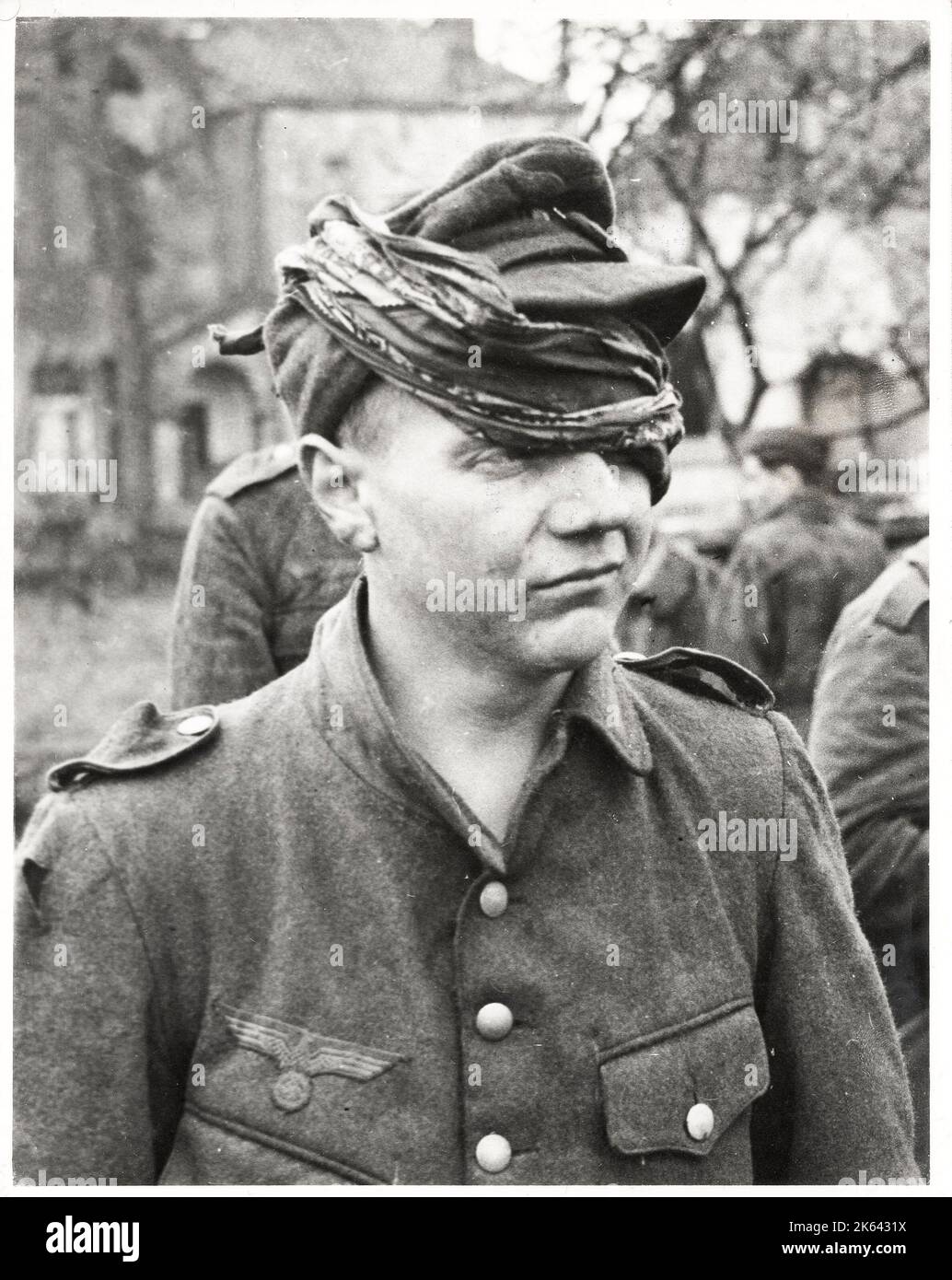 Vintage World War II photograph - a very young captured German soldier with an eye injury Stock Photo