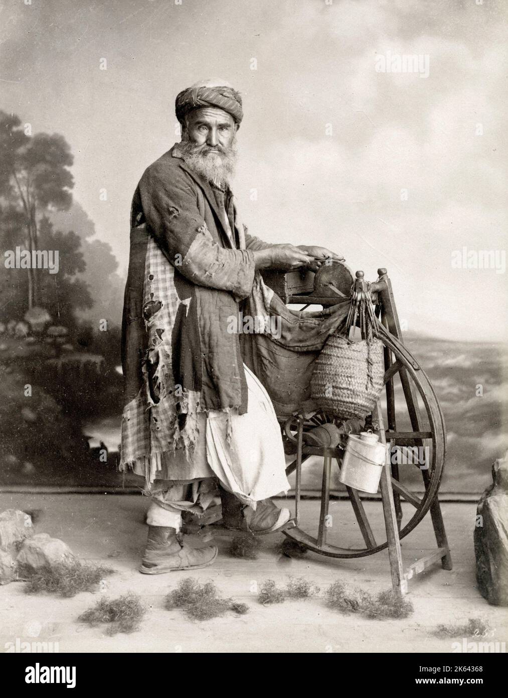 19th century vintage photograph: Bearded Egyptian man sharpening knives on a grind stone Stock Photo