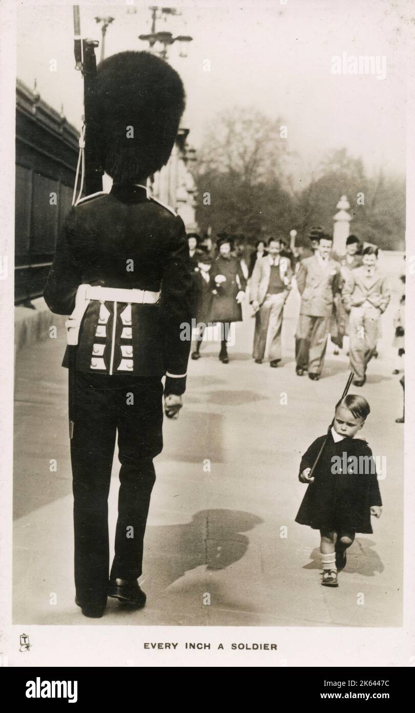 'Every Inch a Soldier' - A youn boy marches past a Guardsman in proud imitation - Buckingham Palace, London Stock Photo