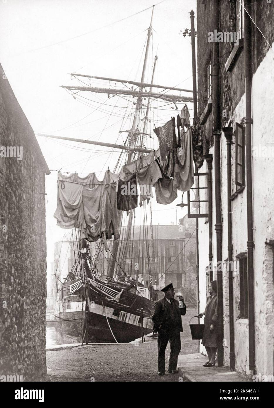 Port scene, with sailor and washing line, UK, 1930's Stock Photo