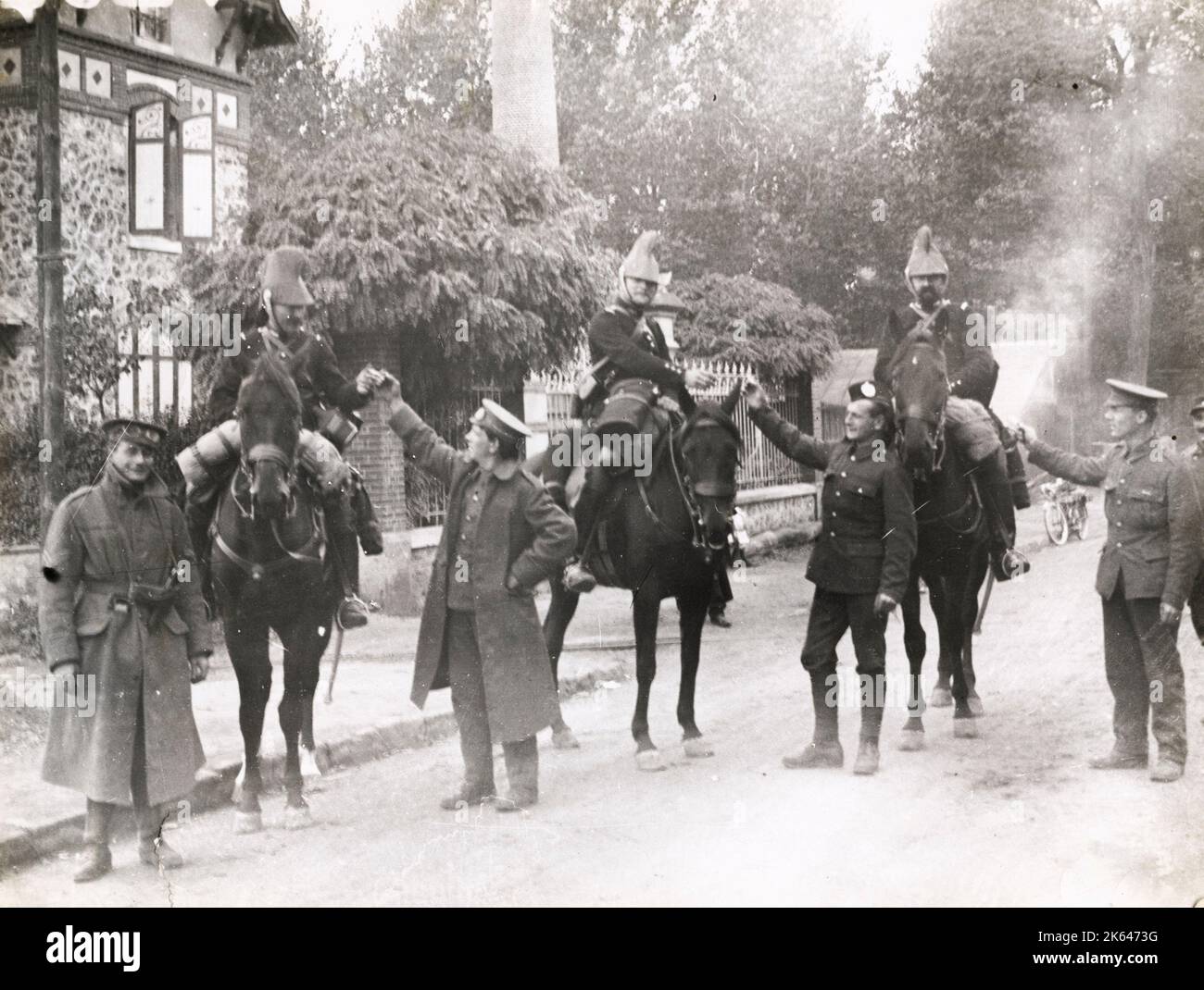 Vintage World War One photograph - WWI: British soldiers offering cigarettes to French cavalry. Stock Photo