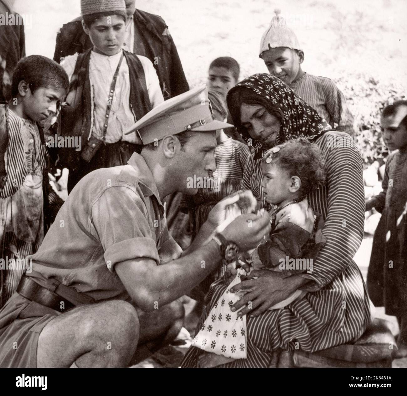 1943 Syria - British military office treats Kurdish people along the Syria Turkey border - many suffering from Trachoma Photograph by a British army recruitment officer stationed in East Africa and the Middle East during World War II Stock Photo