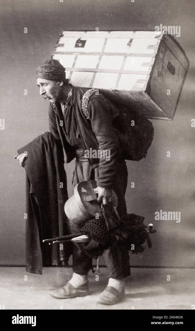 Vintage 19th century photograph - porter with heavy load, probably Turkey. Stock Photo