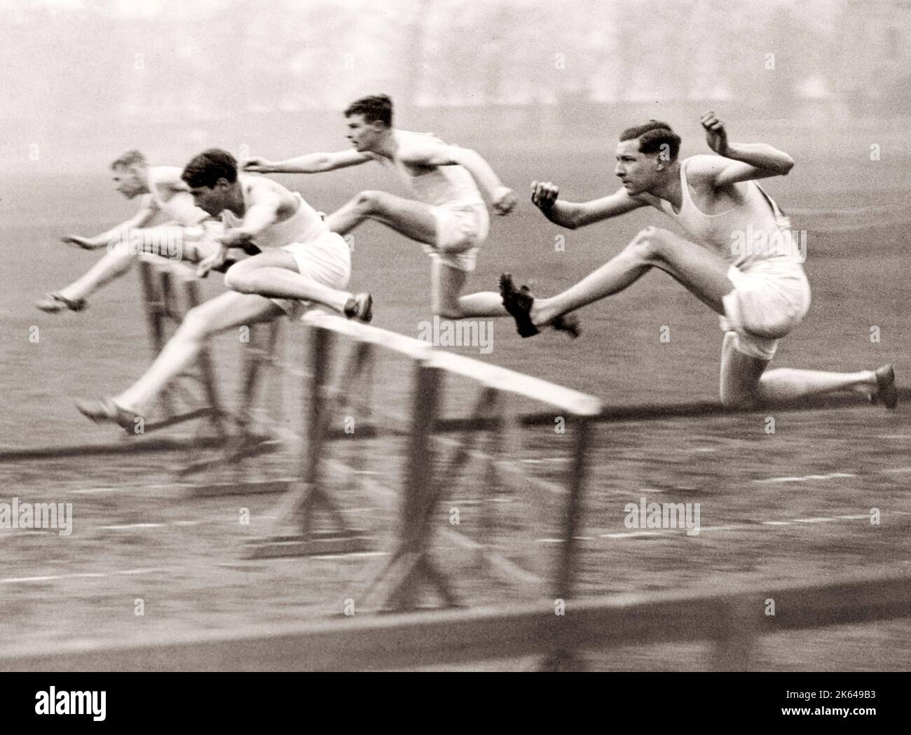 1930's press photo - hurdlers racing Stock Photo