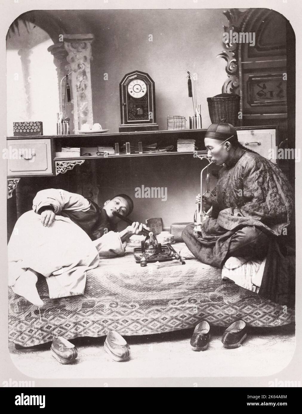 Vintage late 19th century photograph: Opium smokers, drug taking, pipes,  China Stock Photo