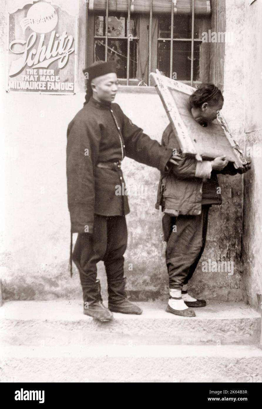 c.1890 China - Chinese  prisoner in cangue and guard Stock Photo