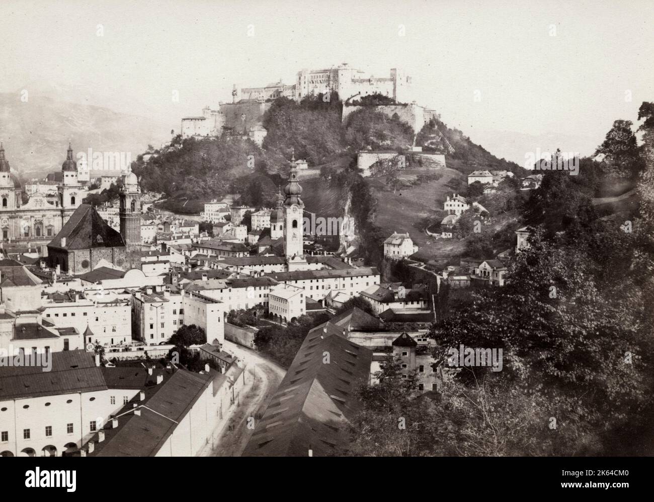 Vintage 19th century photograph - Salzburg is an Austrian city on the border of Germany, with views of the Eastern Alps. The city is divided by the Salzach River, with medieval and baroque buildings of the pedestrian Altstadt (Old City) on its left bank, facing the 19th-century Neustadt (New City) on its right. Stock Photo
