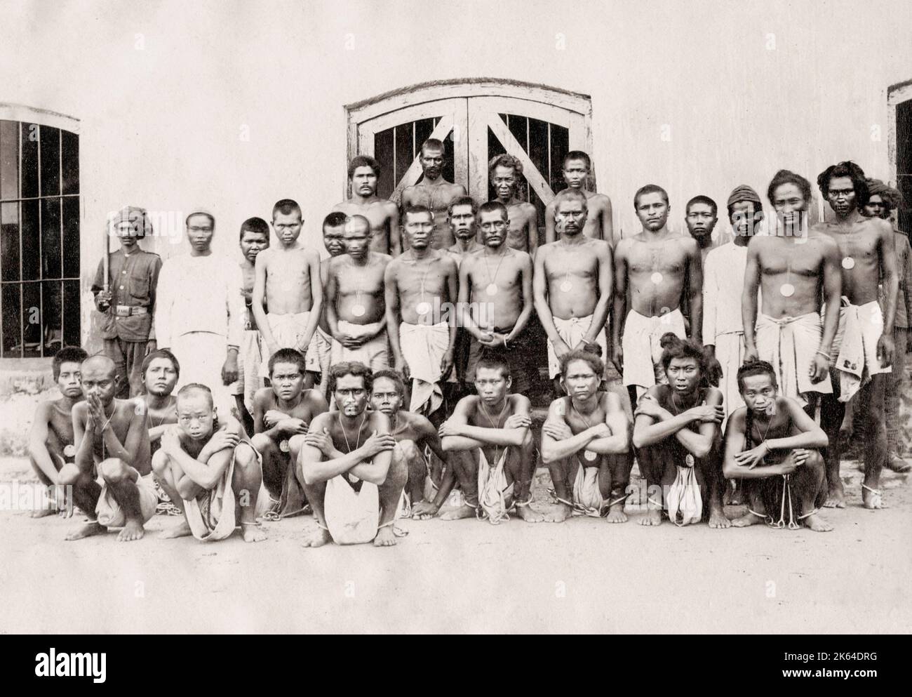 Vintage 19th century photograph: group of prisoners in shackles, irons, India. Stock Photo
