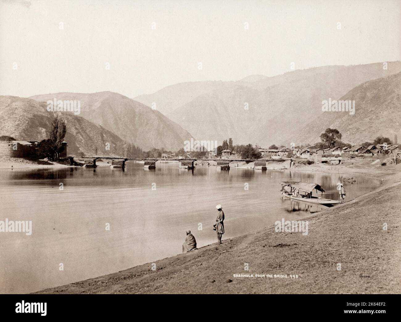 19th century vintage photograph: Baramulla is a city and a municipality in the Baramulla district in the Indian union territory of Jammu and Kashmir. It is on the bank of the Jhelum River downstream from Srinagar, the state capital. The city was earlier known as Vārāhamūla. Stock Photo