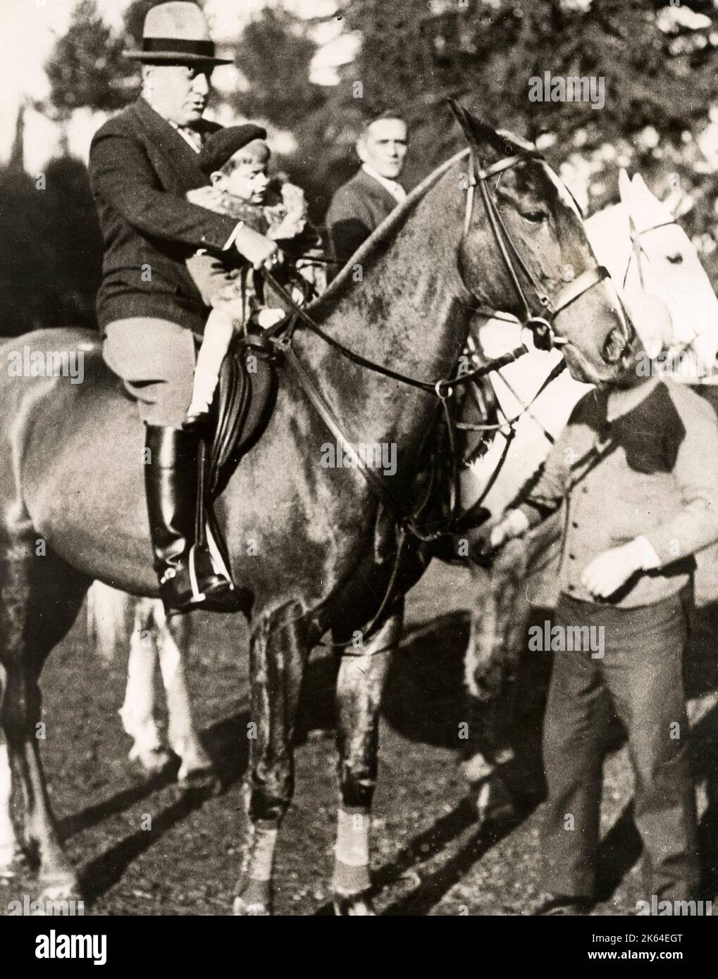 Early 20th century vintage press photograph - Italian fascist leader Benito Mussolini and one of this sons on horseback at Villa Torlonia, Rome, c.1920s Stock Photo