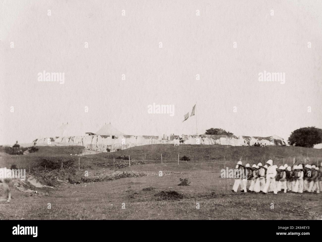 Vintage 19th century photograph: Captioned 'Hova Fort' Tamatave, Toamasina, Madagascar, French soldiers marching past; presumably Fort Manda. Stock Photo