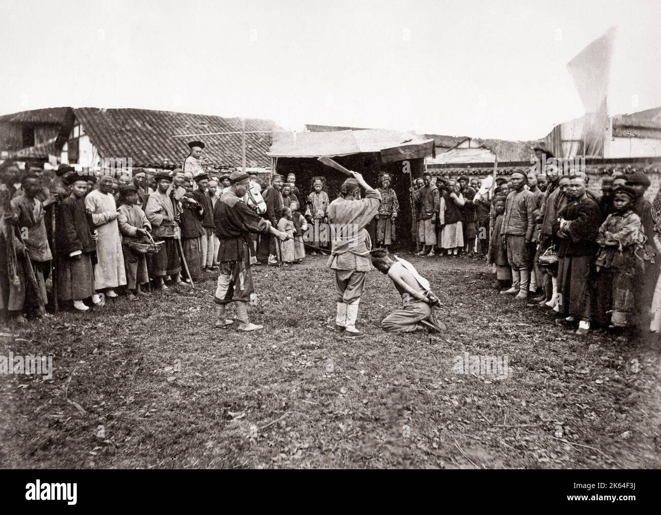 Crowd watching execution by decapitation, China c.1880's Stock Photo