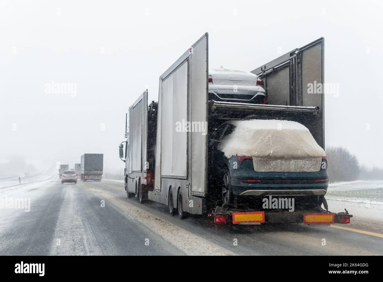 Tow truck car carrier semi trailer on highway carrying batch of new